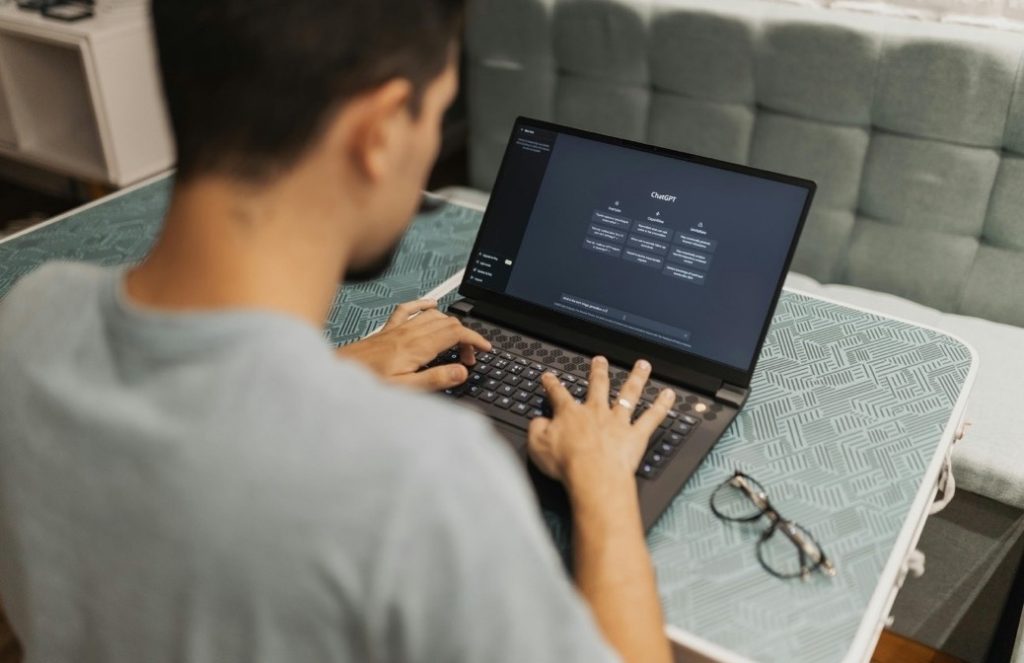A developer coding on a laptop computer