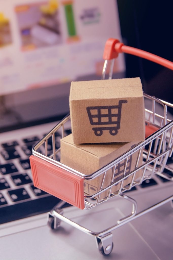 Parcels tucked into a miniature trolley on a computer keyboard